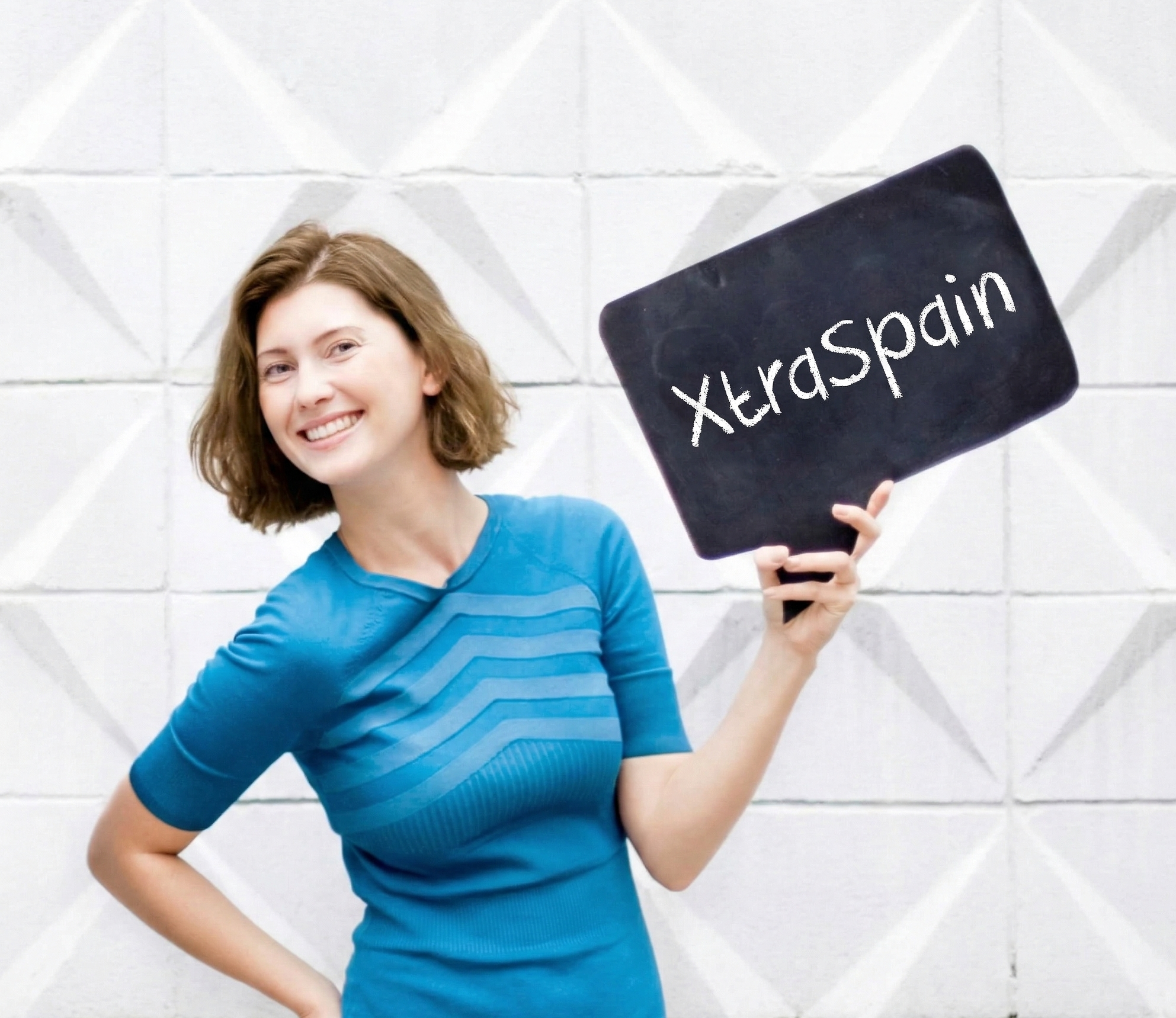 Alisa Zinko, Spain relocation consultant, holding XtraSpain sign
